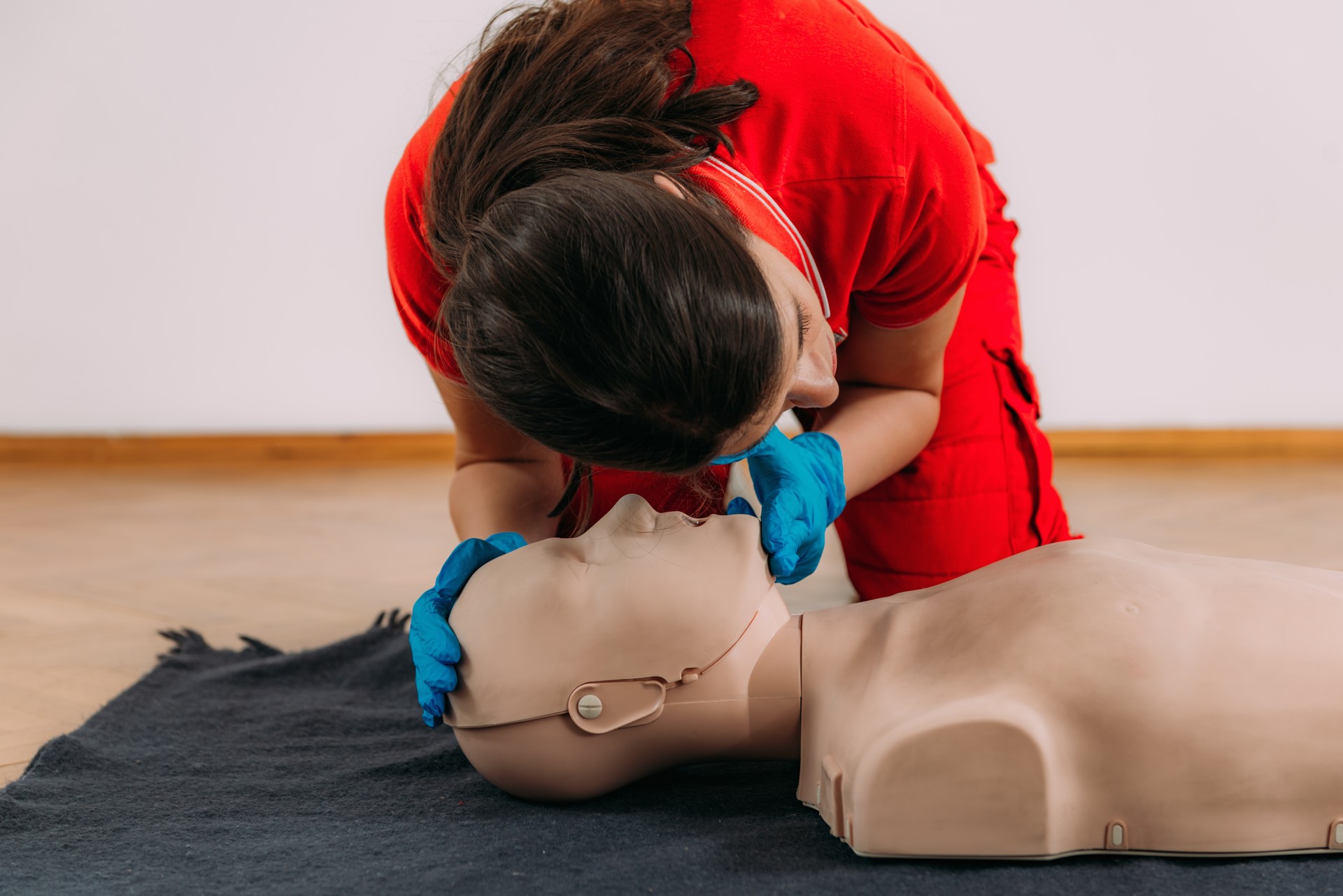 CPR with mouth to mouth technique in a first aid course using a training dummy