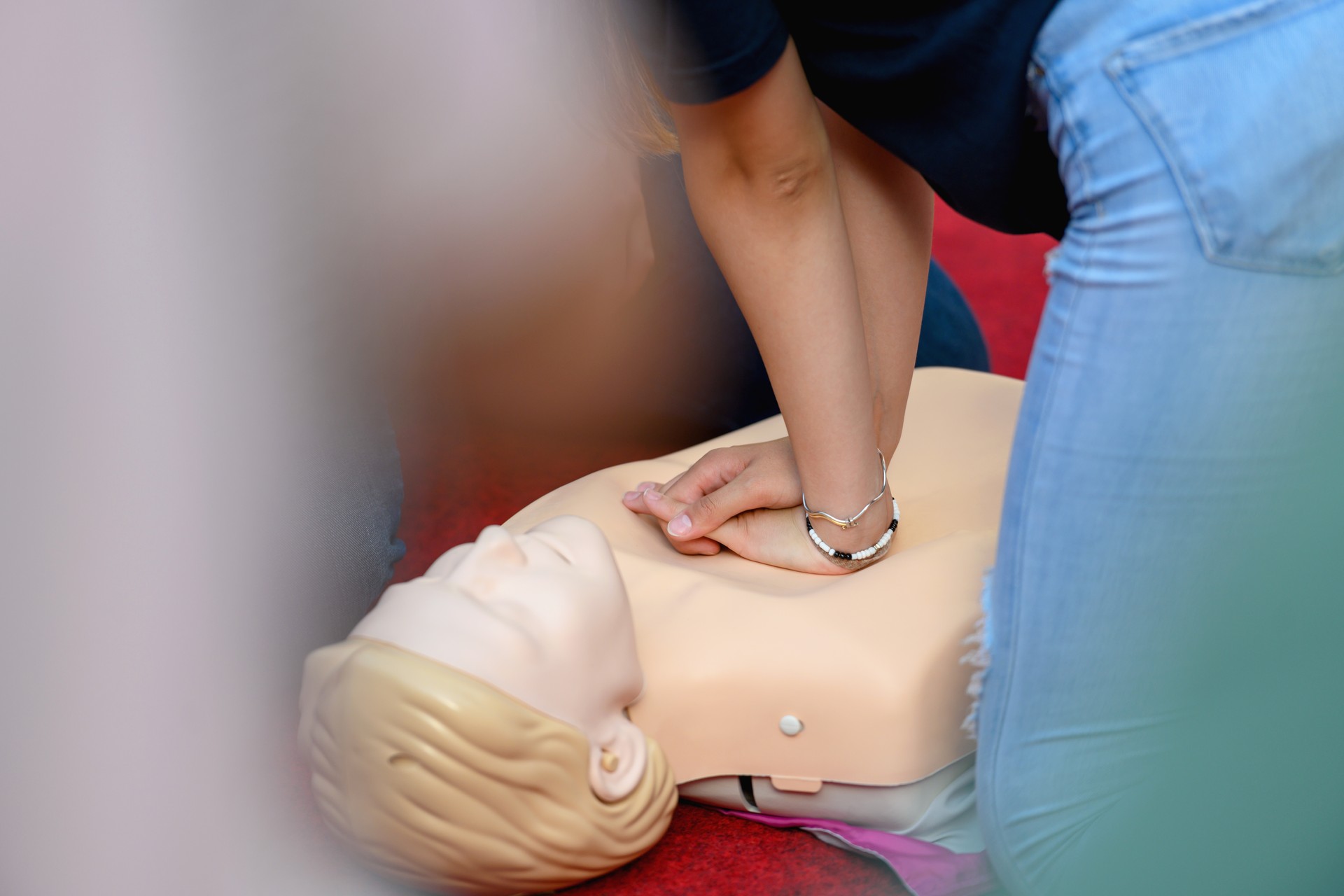 Instructor demonstrating chest compressions to volunteers